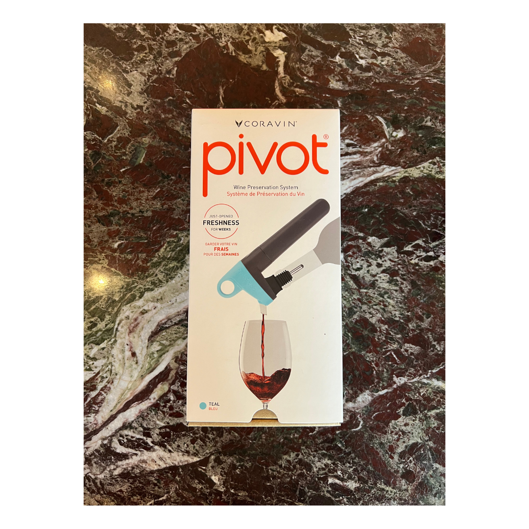 The Coravin Pivot in shade teal, shown in its box on a marble table